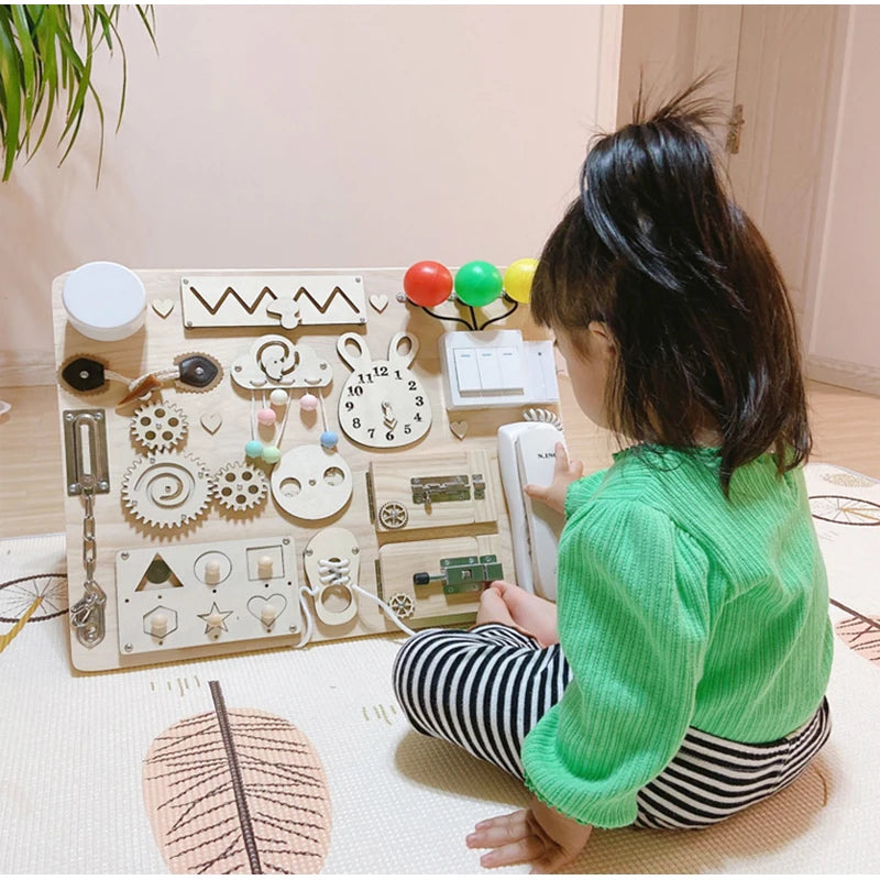 Child playing with a wooden toy set on a light-colored floor.